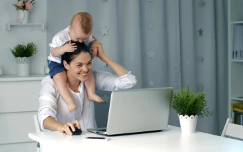 Stock Video Enterprising Mom Plays With Her Baby While Working For PC