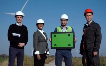 Stock Video Engineers On A Wind Farm Holding A Green Screen For PC