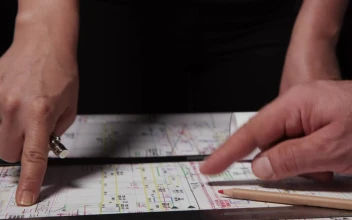 Stock Video Engineers Looking Over Plans For PC