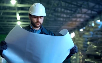 Stock Video Engineer Holding A Blueprint In A Warehouse For PC