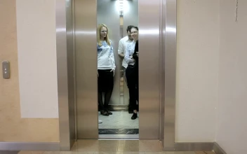 Stock Video Elevator Opens To Reveal Young Business People For PC