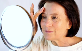 Stock Video Elderly Woman Touching Her Face In A Small Mirror For PC
