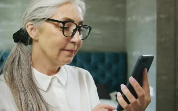 Stock Video Elderly Woman Texts On Mobile Phone And Smiles For PC
