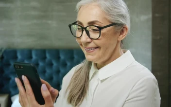 Stock Video Elderly Woman Smiles While Using Mobile App For PC