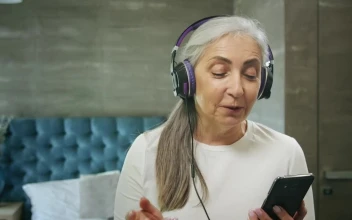 Stock Video Elderly Woman Enjoys Music App With Headphones For PC