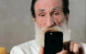 Stock Video Elderly Man Confused By Mobile App For PC