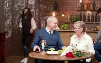 Stock Video Elderly Couple Pay For Dinner With Mobile Phone For PC