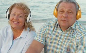 Stock Video Elderly Couple Enjoying Music At The Beach For PC