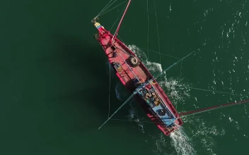 Stock Video Drone Following A Small Red Fishing Boat For PC