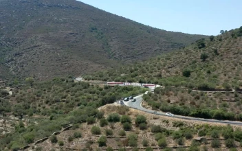 Stock Video Drone Flying Along A Winding Road In The Hills For PC