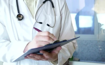 Stock Video Doctor Writing On A Medical Record For PC