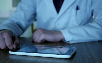 Stock Video Doctor Using A Tablet On The Desk For PC