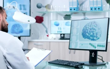 Stock Video Doctor Takes Notes While Reviewing Dna And Brain Models For PC