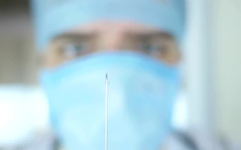 Stock Video Doctor Looking At The Syringe For PC