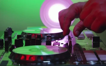 Stock Video Dj Using A Mixer Table For PC