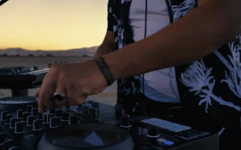 Stock Video Dj Mixing With His Equipment In A Desert For PC