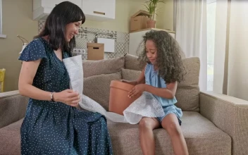 Stock Video Diverse Mom And Daughter Play On Sofa In New Home For PC