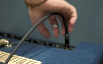 Stock Video Disconnecting An Instrument From An Amplifier For PC