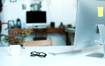 Stock Video Desk View Of Woman Walking Bike Into Modern Office For PC