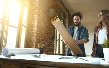 Stock Video Designers Unroll Plans Onto Desk In Studio For PC