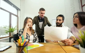 Stock Video Design Team Review Prototype In Modern Minimalist Office For PC