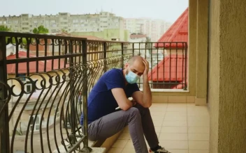 Stock Video Depressed Man Wearing Mask Sits On Balcony In Covid Lockdown For PC