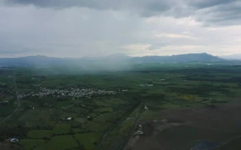 Stock Video Mixkit Flying Over A Large Plain With A Town Plots And Smal For PC