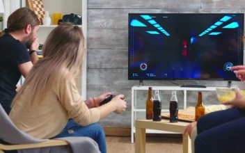 Stock Video Friends Enjoy Video Gaming On Sofa At Party For PC