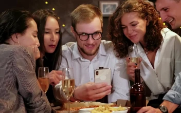 Stock Video Friends Celebrating A Special Date Look At A Cell Phone For PC
