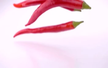 Stock Video Fresh Red Chili Peppers Falling Into Water For PC