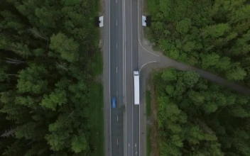 Stock Video Freight Trucks Heading Through A Forest For PC
