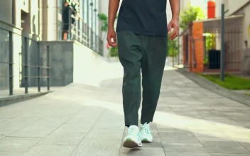 Stock Video Footsteps Of A Young Man Walking Down The Street For PC
