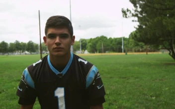 Stock Video Football Player Putting On A Helmet For PC