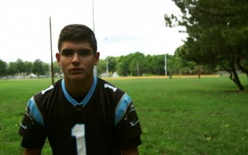 Stock Video Football Player Putting On A Blue Helmet For PC