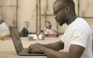 Stock Video Focused Man Types On Laptop In Outdoor Cafe For PC
