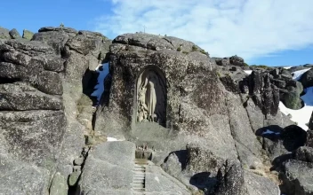 Stock Video Flying Towards A Statue Encrusted In The Rocks For PC