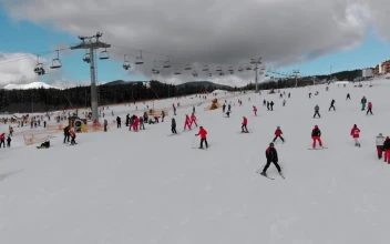 Stock Video Flying Over Skiers In The Snowy Mountain For PC