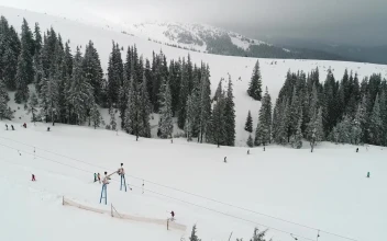 Stock Video Flying Over Mountains Slope With Skiers For PC