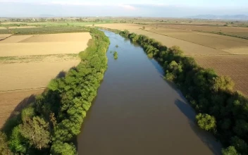 Stock Video Flying Over A River Between Agricultural Fields For PC