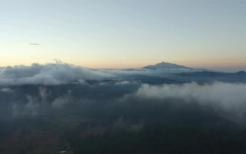 Stock Video Flying Over A Mountainous Landscape Covered With Clouds For PC
