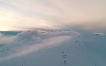 Stock Video Flying Over A Full Snow Covered Mountain Range For PC