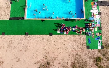 Stock Video Flying Over A Crowded Swimming Pool For PC
