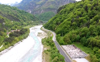 Stock Video Flying Over A Cemetery And A Road By The River For PC