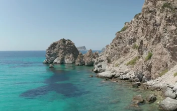 Stock Video Flying On The Rocky Shore Of A Turquoise Blue Sea For PC
