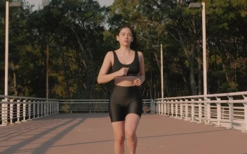 Stock Video Fit Woman From The Front Jogging Down The Street For PC