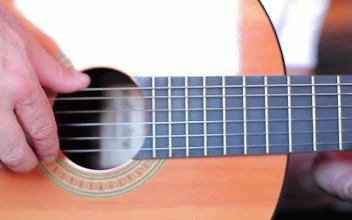 Stock Video Fingers Of A Man Playing The Strings Of A Guitar For PC