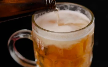 Stock Video Filling A Mug With Beer On A Dark Background For PC
