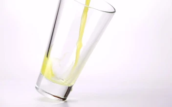 Stock Video Filling A Glass With Juice On A White Background For PC