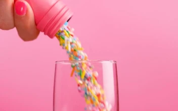 Stock Video Filling A Glass Cup With Small Sweets On A Pink For PC