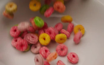 Stock Video Filling A Bowl With Colored Ring Cereal For PC